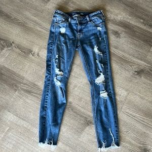 Old Navy mid-rise rockstar super skinny jeans with intentional rips all over.